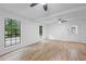 Bright living room featuring hardwood floors, large windows, and a modern ceiling fan for comfort at 3345 Bomar Rd, Douglasville, GA 30135