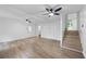 Open-concept living room with hardwood flooring, a staircase, and ample natural light from the exterior doors at 3345 Bomar Rd, Douglasville, GA 30135