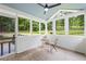 Relaxing screened porch with vaulted ceiling and an outdoor ceiling fan at 3345 Bomar Rd, Douglasville, GA 30135