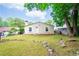 Well-manicured backyard featuring a lush lawn, mature trees, and a home with a bright, white exterior at 3349 Lavista Dr, Atlanta, GA 30354