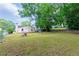 Spacious backyard featuring a lush lawn, mature trees, and a home with a bright, white exterior at 3349 Lavista Dr, Atlanta, GA 30354