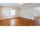 Sunlit bedroom featuring hardwood floors and a view leading into the living room with a fireplace at 3349 Lavista Dr, Atlanta, GA 30354