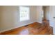 This bedroom has neutral walls, wood floors, a window, and a white door leading to another room at 3349 Lavista Dr, Atlanta, GA 30354