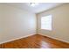This bedroom features neutral walls, wood floors, a window that lets in plenty of natural light, and a ceiling fan at 3349 Lavista Dr, Atlanta, GA 30354