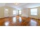 Bright living room featuring hardwood floors, a white brick fireplace, and multiple windows for natural light at 3349 Lavista Dr, Atlanta, GA 30354