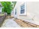 Narrow side yard featuring a stone path, bright white exterior, and a fenced boundary at 3349 Lavista Dr, Atlanta, GA 30354
