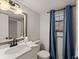 Updated bathroom with vanity, modern fixtures, and framed mirror at 1101 New Horizon St, Powder Springs, GA 30127