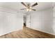 Spacious bedroom with wood-look floors, ceiling fan, and double closet at 1101 New Horizon St, Powder Springs, GA 30127
