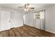 Bedroom with wood-look floors, ceiling fan, closet, and natural light at 1101 New Horizon St, Powder Springs, GA 30127
