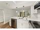 Renovated kitchen featuring stainless steel appliances, white cabinets, and modern fixtures at 1101 New Horizon St, Powder Springs, GA 30127