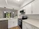 Updated kitchen with white cabinets, stainless steel appliances, and modern lighting fixtures at 1101 New Horizon St, Powder Springs, GA 30127