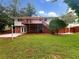 Backyard with a deck, a brick wall foundation and green grass at 2784 Williamsburg Way, Decatur, GA 30034