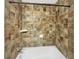 Full bathroom featuring tiled walls and shower over tub at 2784 Williamsburg Way, Decatur, GA 30034
