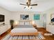 Staged bedroom with hardwood floors, a ceiling fan, and large windows at 2784 Williamsburg Way, Decatur, GA 30034