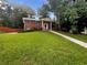 Charming red brick home with a manicured lawn and walkway leading to the front door at 2784 Williamsburg Way, Decatur, GA 30034