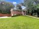 Charming red brick home with a manicured lawn and walkway leading to the front door at 2784 Williamsburg Way, Decatur, GA 30034