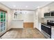 Modern kitchen with stainless steel appliances and view into the living room at 2784 Williamsburg Way, Decatur, GA 30034