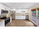 Modern kitchen with white cabinets, stainless steel appliances, and a tile backsplash at 2784 Williamsburg Way, Decatur, GA 30034