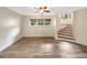 Light filled living room features wood flooring, stairs, and windows at 2784 Williamsburg Way, Decatur, GA 30034