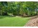 Beautiful backyard featuring mature landscaping, bridge and natural scenery at 3402 Johnson Ferry Rd, Roswell, GA 30075