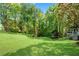 Expansive backyard featuring mature trees and outdoor structure with staircase at 3402 Johnson Ferry Rd, Roswell, GA 30075