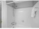 Clean bathroom featuring a tiled shower and bathtub, complete with shower head and towel rack at 3402 Johnson Ferry Rd, Roswell, GA 30075