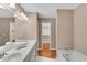 Bathroom with double vanity, bathtub, and view to the walk-in closet at 3402 Johnson Ferry Rd, Roswell, GA 30075