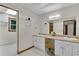 Bathroom with dual sinks, vanity, and large mirror, offering ample counter space at 3402 Johnson Ferry Rd, Roswell, GA 30075