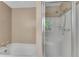 Bathroom showcasing a combined bathtub and shower with a sliding glass door and tile surround at 3402 Johnson Ferry Rd, Roswell, GA 30075