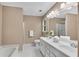 Bathroom with dual sinks, bathtub, shower, and vanity with storage at 3402 Johnson Ferry Rd, Roswell, GA 30075
