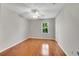 Bedroom with hardwood floors, neutral paint, a ceiling fan, and natural light at 3402 Johnson Ferry Rd, Roswell, GA 30075