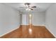 Bedroom with hardwood floors, ceiling fan, and a view to the en-suite bathroom at 3402 Johnson Ferry Rd, Roswell, GA 30075