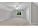 Spacious bedroom with plush carpet, a ceiling fan, neutral walls, and a bright window for a serene retreat at 3402 Johnson Ferry Rd, Roswell, GA 30075