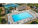Aerial view of large community pool, tennis courts, playground, and lots of lounging chairs at 3402 Johnson Ferry Rd, Roswell, GA 30075