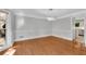 Dining room with hardwood floors, stylish lighting fixture, and neutral wall colors at 3402 Johnson Ferry Rd, Roswell, GA 30075