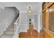 Elegant foyer with staircase, hardwood floors, and decorative lighting fixture at 3402 Johnson Ferry Rd, Roswell, GA 30075