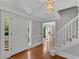 Bright and airy foyer with hardwood floors, staircase, and neutral wall colors at 3402 Johnson Ferry Rd, Roswell, GA 30075