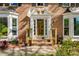 Inviting front entrance with brick steps, ornate details, and manicured landscaping at 3402 Johnson Ferry Rd, Roswell, GA 30075