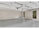 Spacious two-car garage featuring clean epoxy flooring, painted walls, and bright natural light from windows at 3402 Johnson Ferry Rd, Roswell, GA 30075