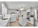 Modern kitchen with stainless steel appliances, island with seating, and ample counter space at 3402 Johnson Ferry Rd, Roswell, GA 30075
