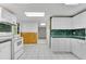 Open kitchen with white cabinets, checkered tile flooring, and stylish countertops at 3402 Johnson Ferry Rd, Roswell, GA 30075