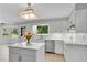 Bright kitchen with stainless steel appliances, island, and charming backsplash at 3402 Johnson Ferry Rd, Roswell, GA 30075