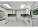Bright kitchen with white cabinets, and modern appliances, designed for both functionality and style at 3402 Johnson Ferry Rd, Roswell, GA 30075