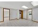 Bright room with multiple doorways, white walls, and tile flooring at 3402 Johnson Ferry Rd, Roswell, GA 30075