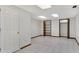 A spacious room with white walls, tile flooring, a closet, and two doorways at 3402 Johnson Ferry Rd, Roswell, GA 30075