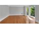 Spacious living room with hardwood floors, large windows, and neutral wall colors at 3402 Johnson Ferry Rd, Roswell, GA 30075