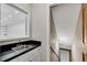 Powder room with dark countertop and access to the stairs at 3402 Johnson Ferry Rd, Roswell, GA 30075