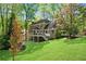 Well-maintained rear exterior featuring brick, deck, and access to green yard at 3402 Johnson Ferry Rd, Roswell, GA 30075