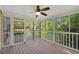 Relaxing screened porch with wood flooring and views of the lush, green backyard at 3402 Johnson Ferry Rd, Roswell, GA 30075