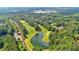 Picturesque aerial view showcases a golf course community with lush greenery, lake, and beautiful homes at 4012 Ironhill Ln, Woodstock, GA 30189